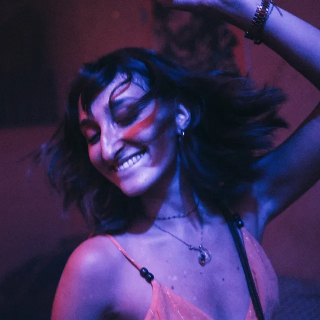 Close up of young girl dancing in club