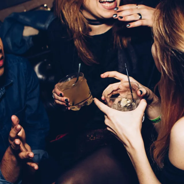 Cropped image of ladies with cocktails in hand