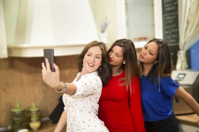 Young women taking selfie with smart phone at home 000070919941 Large
