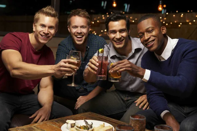 Portrait Of Male Friends Enjoying Night Out At Rooftop Bar 000083961543 Large jpg