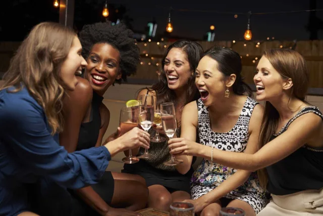 Group Of Female Friends Enjoying Night Out At Rooftop Bar 000083961111 Large