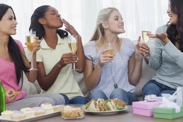 Friends drinking white wine and chatting during party 000040632298 Medium 1